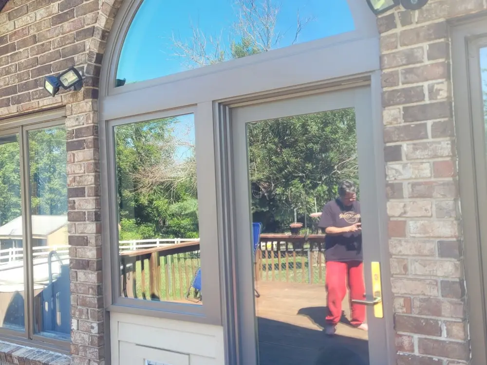 Arched window set into a brick exterior wall