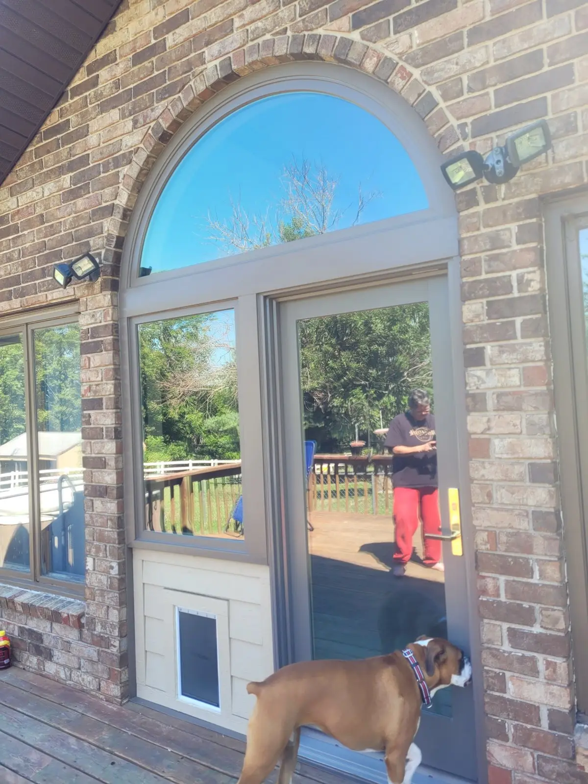 Arched window set into a brick exterior wall