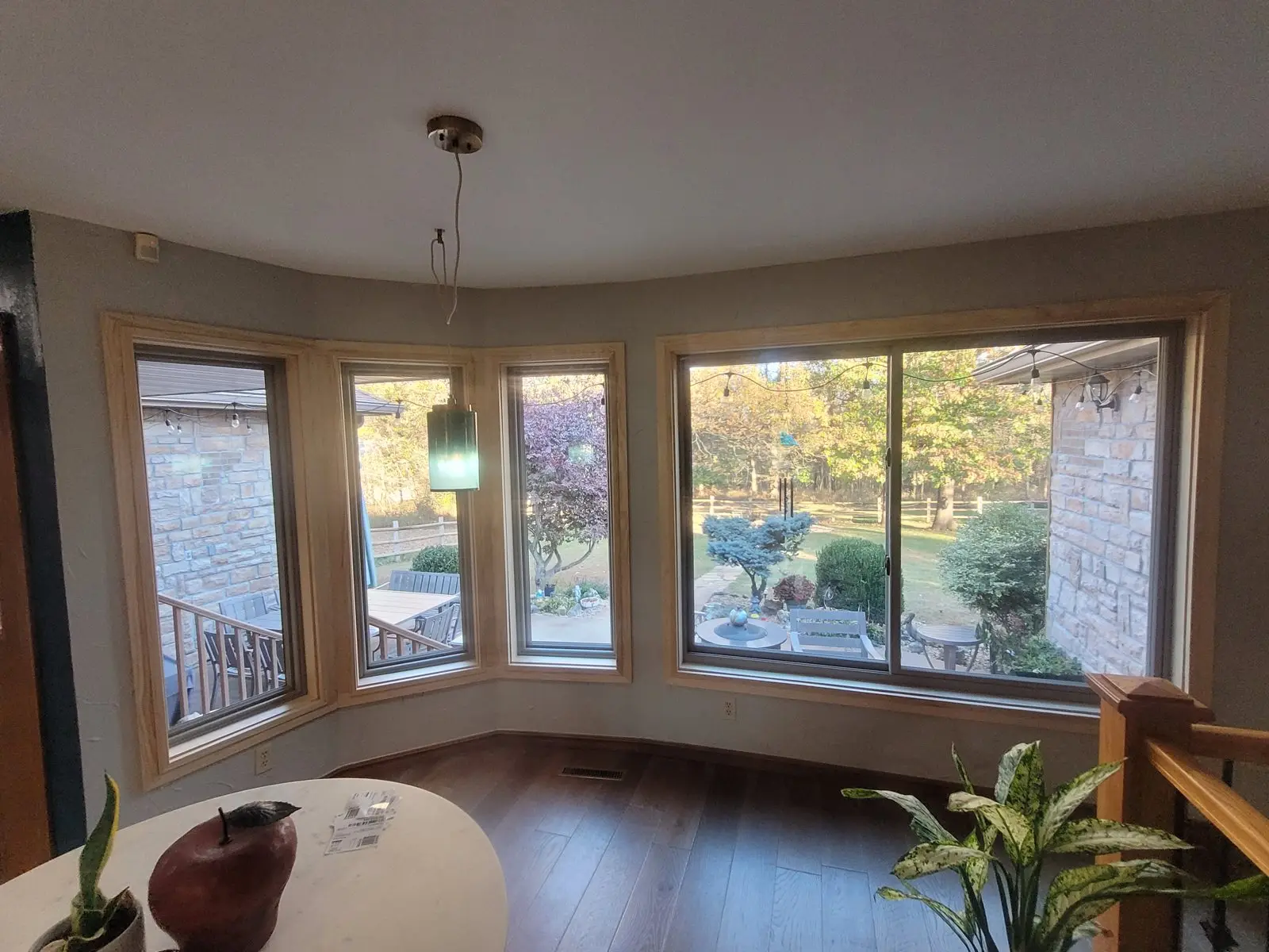 Bay window with new wood trim looking out over a yard