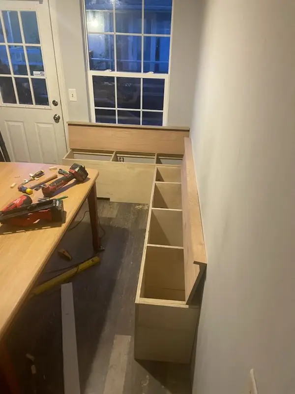 Built-in cabinet boxes under construction with tools on the counter
