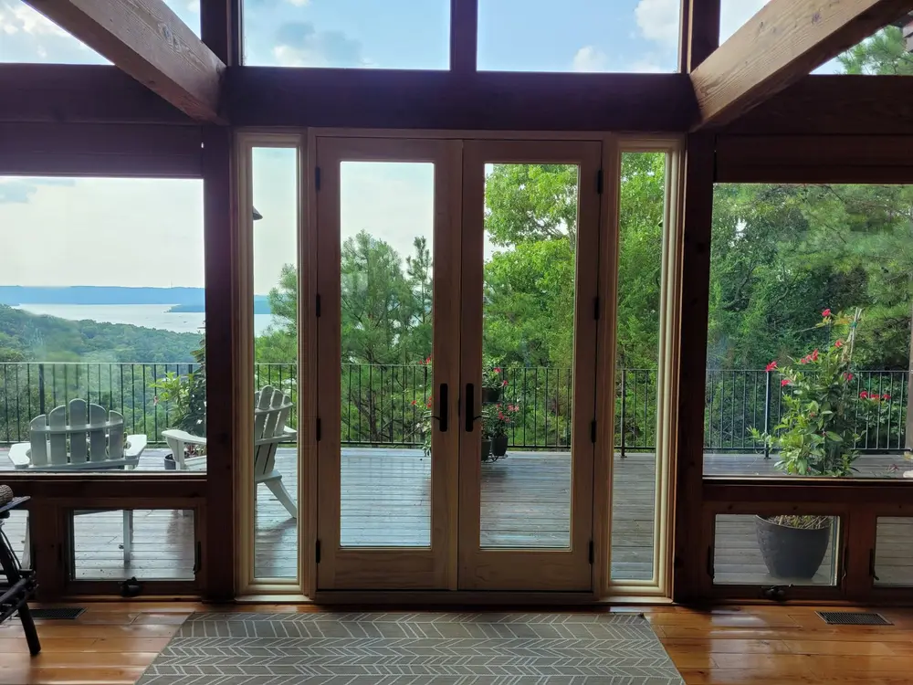 French doors opening onto a deck, installed and trimmed by Colton's crew