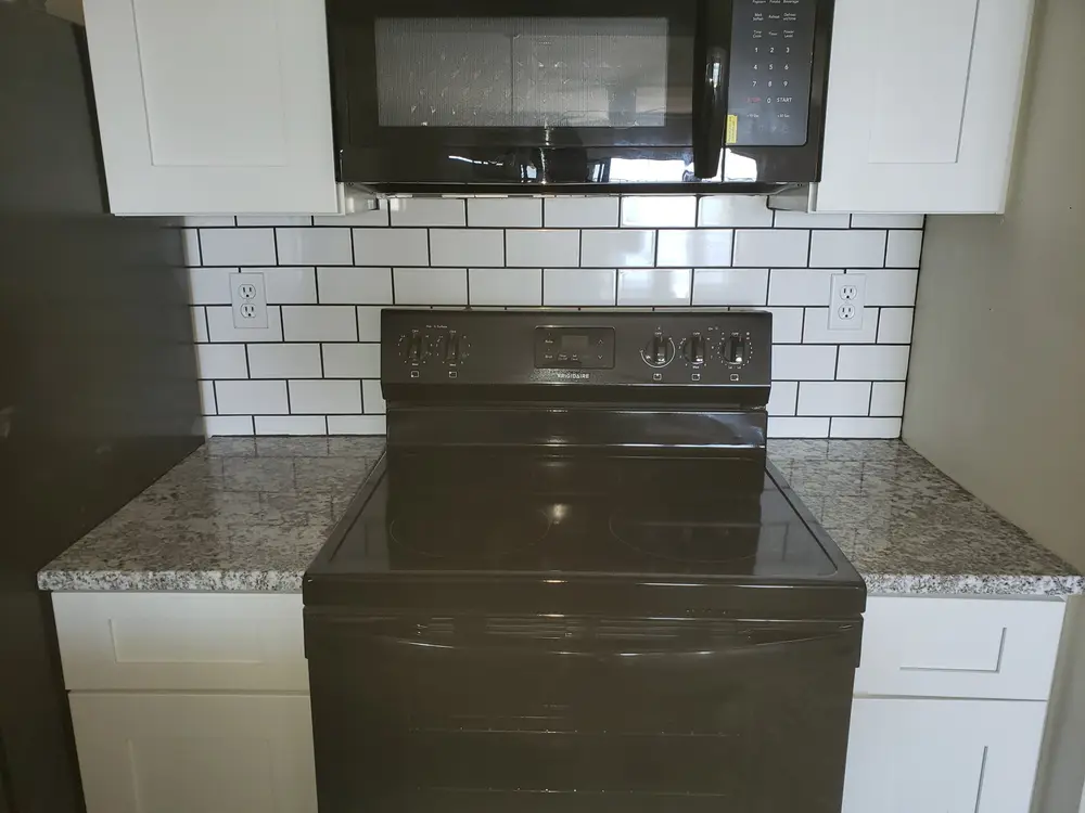 White subway tile backsplash set by the same tile crew