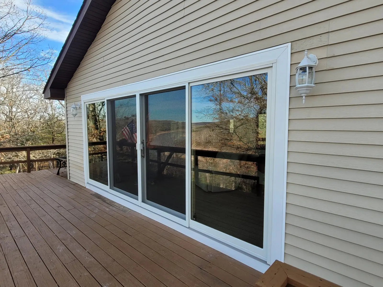 New siding around a sliding glass door on the deck side of a home