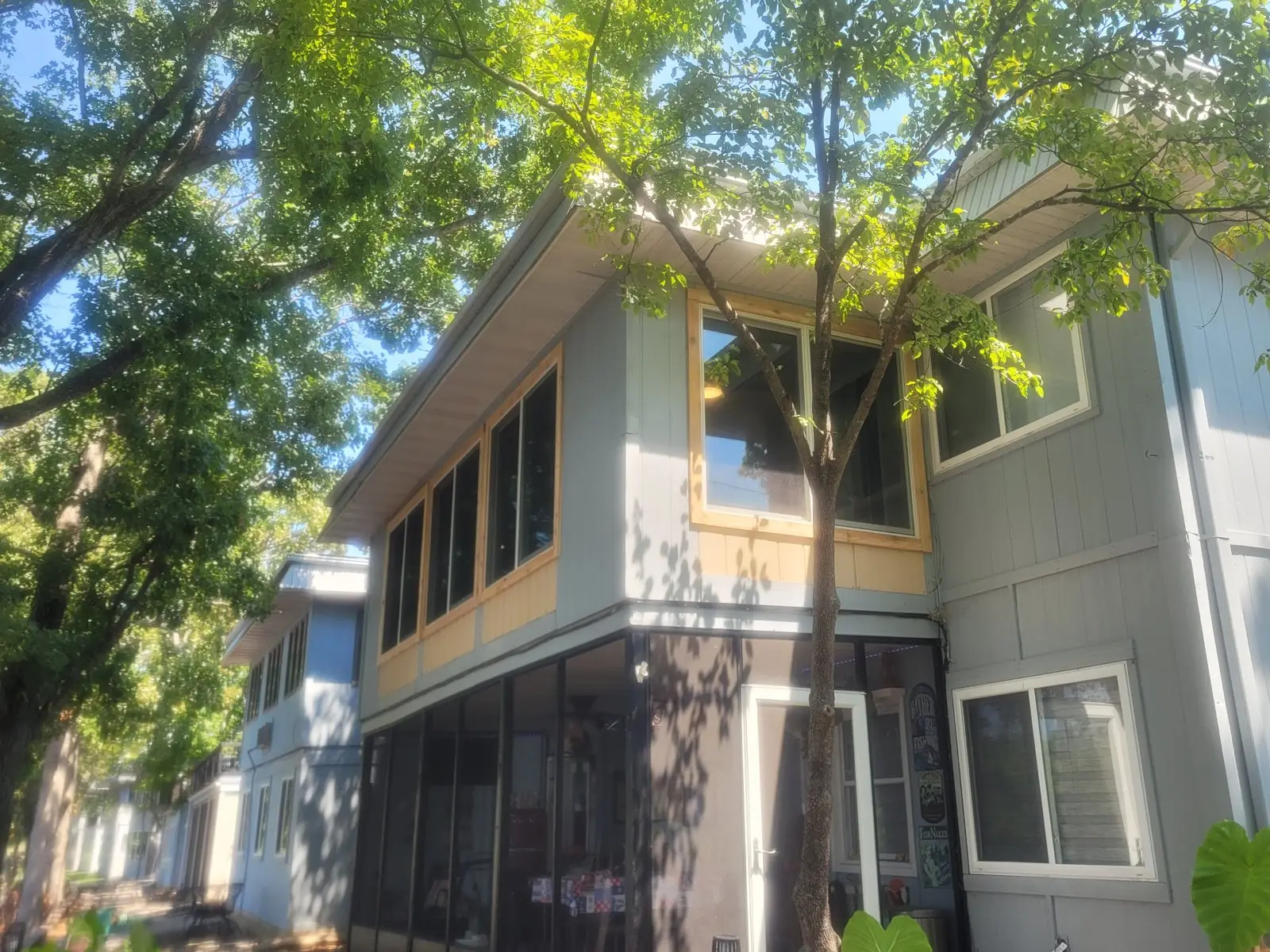 Exterior of a home with a sunroom addition and new windows