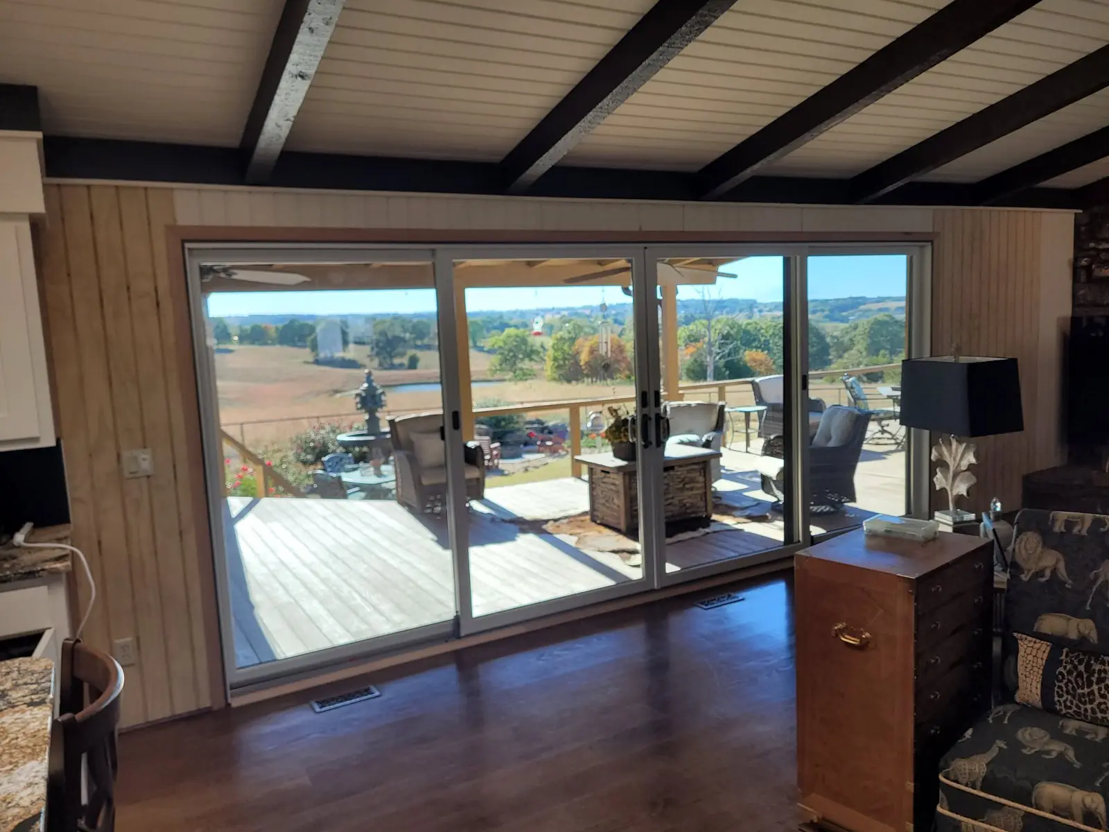 Sunroom sliding doors looking out onto a deck and fields