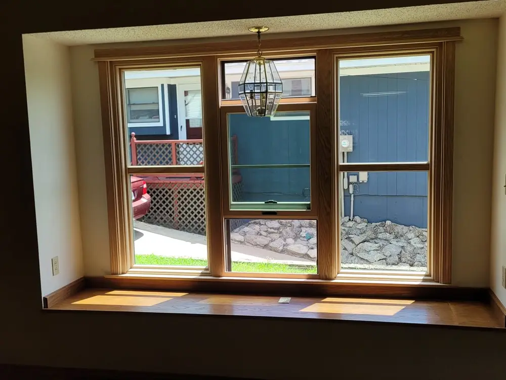 New wood window casing and sill installed on an interior wall